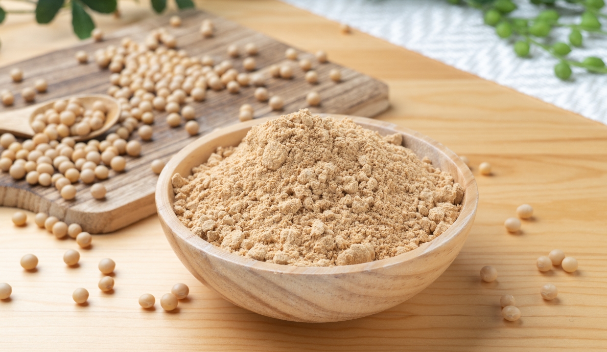 Soy Flour in a bowl surrounded by soy beans